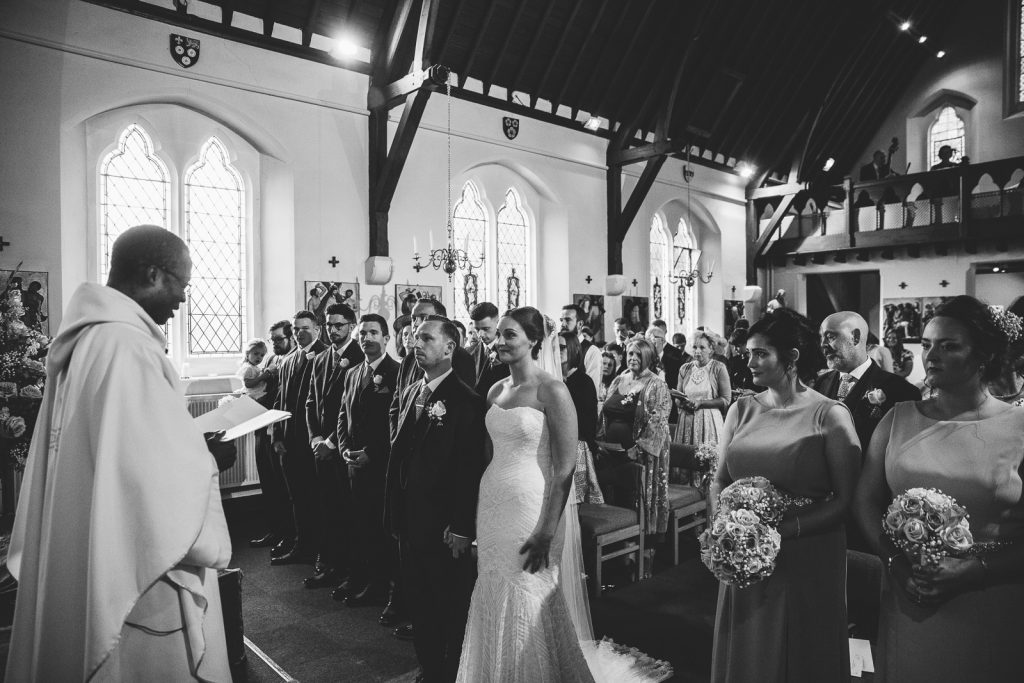 Bride and Groom standing at the alter during catholic wedding ceremony