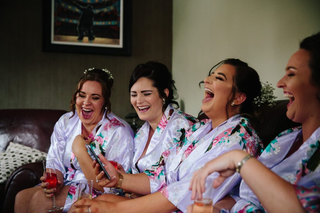 bridesmaids laughing on wedding morning
