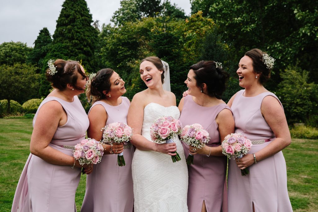 Bride and her bridesmaids laughing
