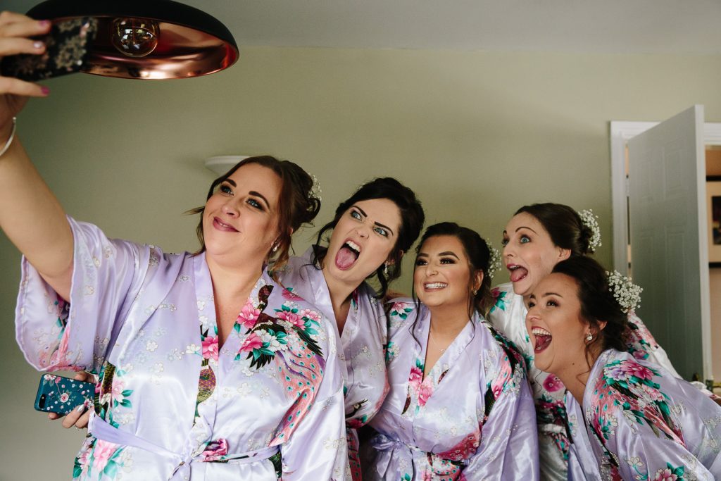 bridesmaids and bride taking a selfie on wedding morning