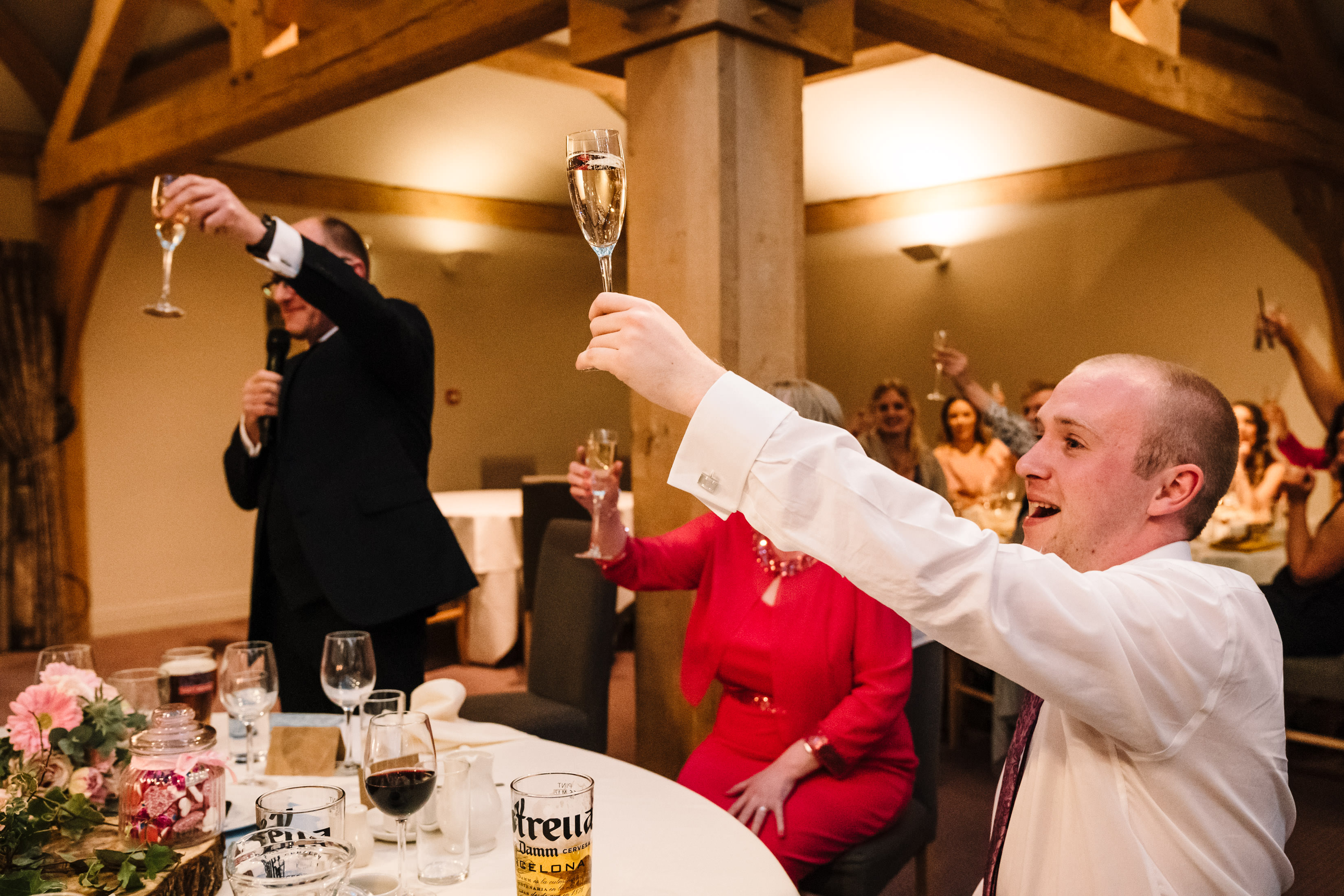 Guests raising a glass during speeches, white hart inn wedding