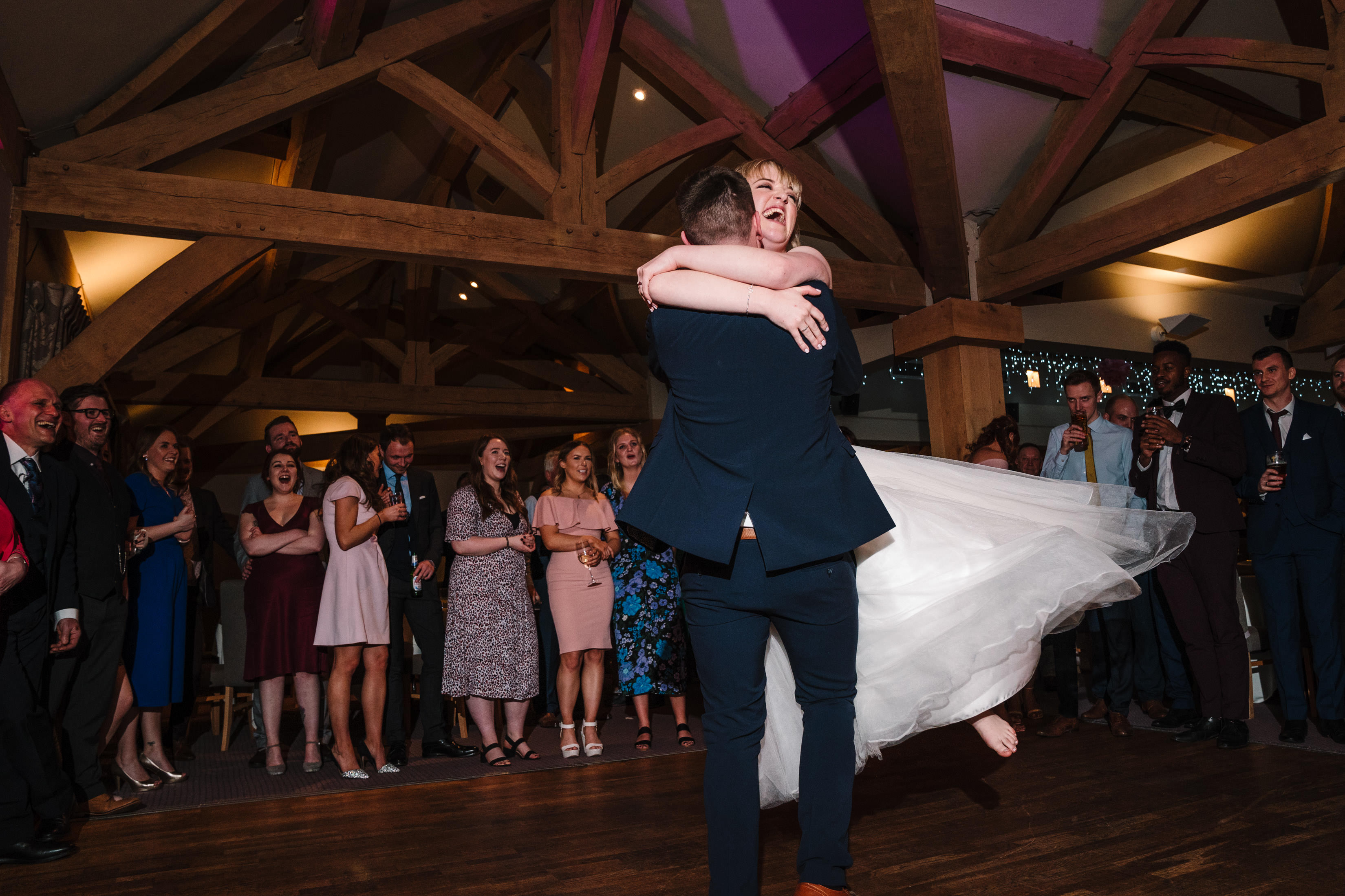 Groom swinging bride around during first dance, at white art inn wedding
