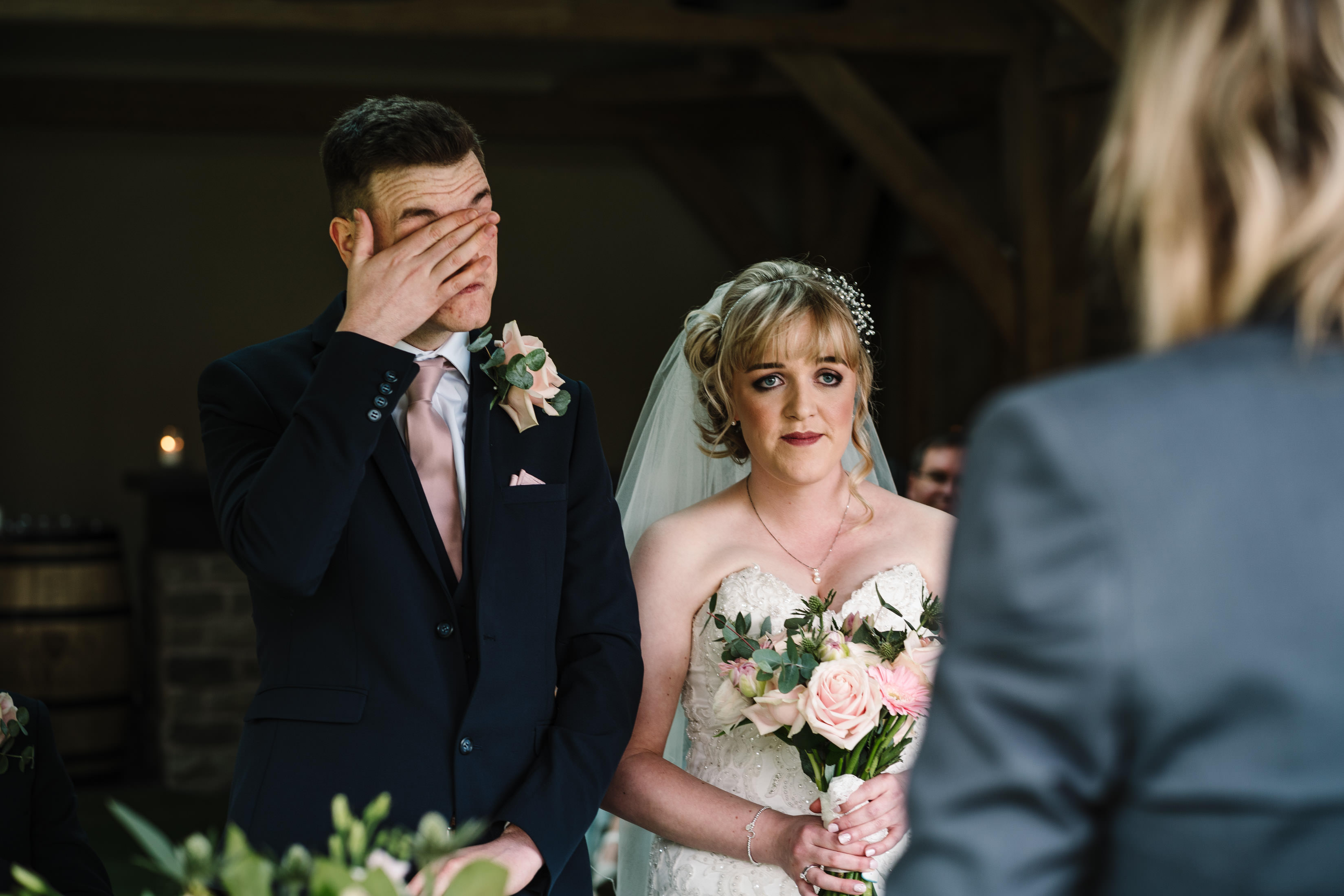 Groom wiping his tears away during wedding ceremony