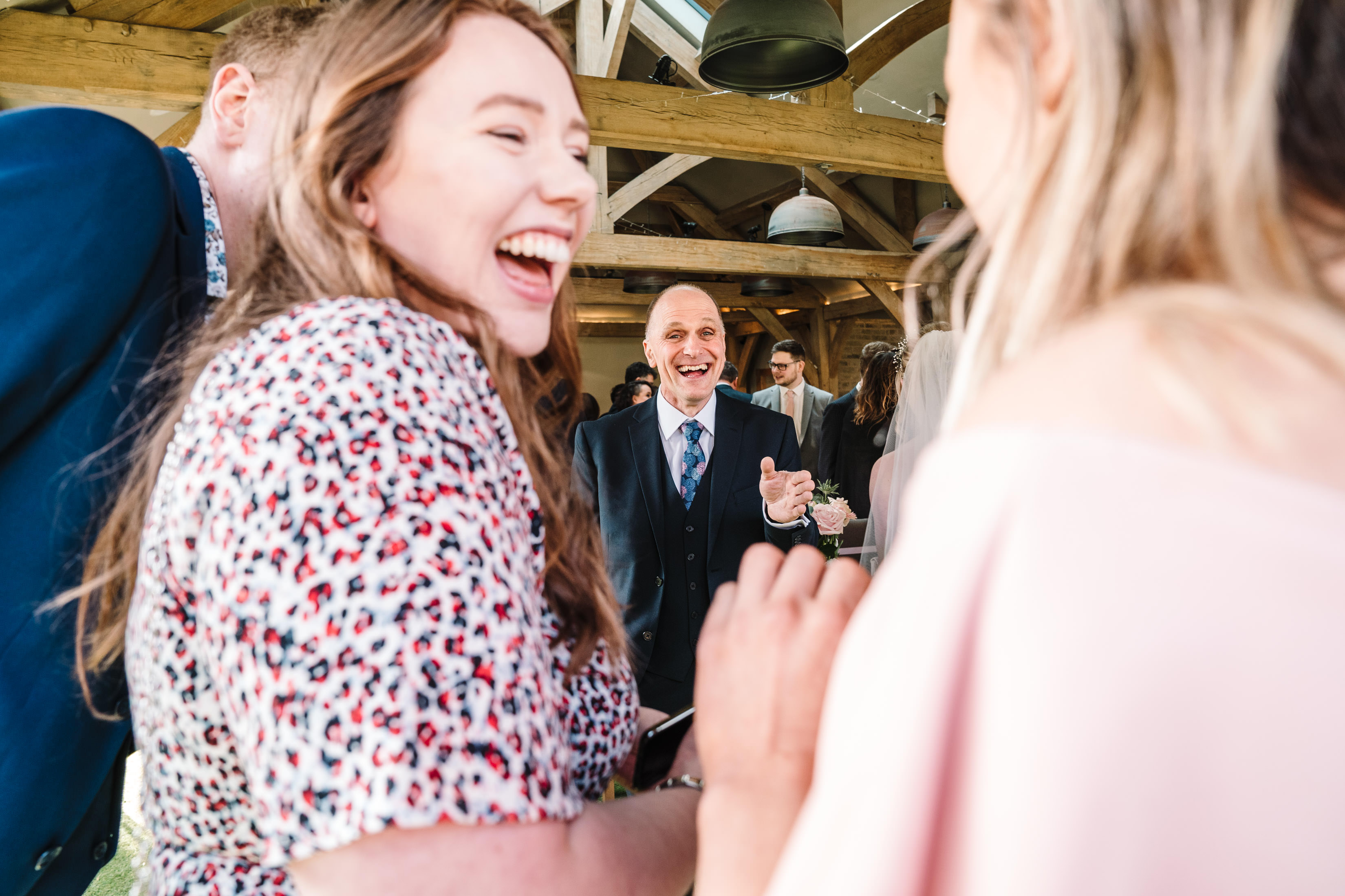 Guests laughing at white hart in wedding