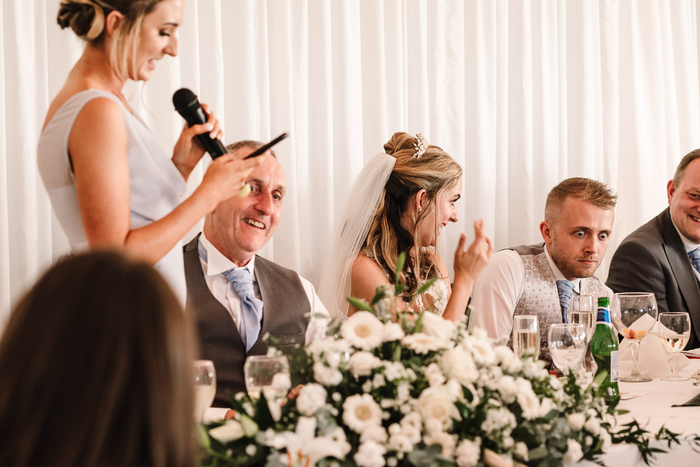 groom pulling a funny face during wedding speech