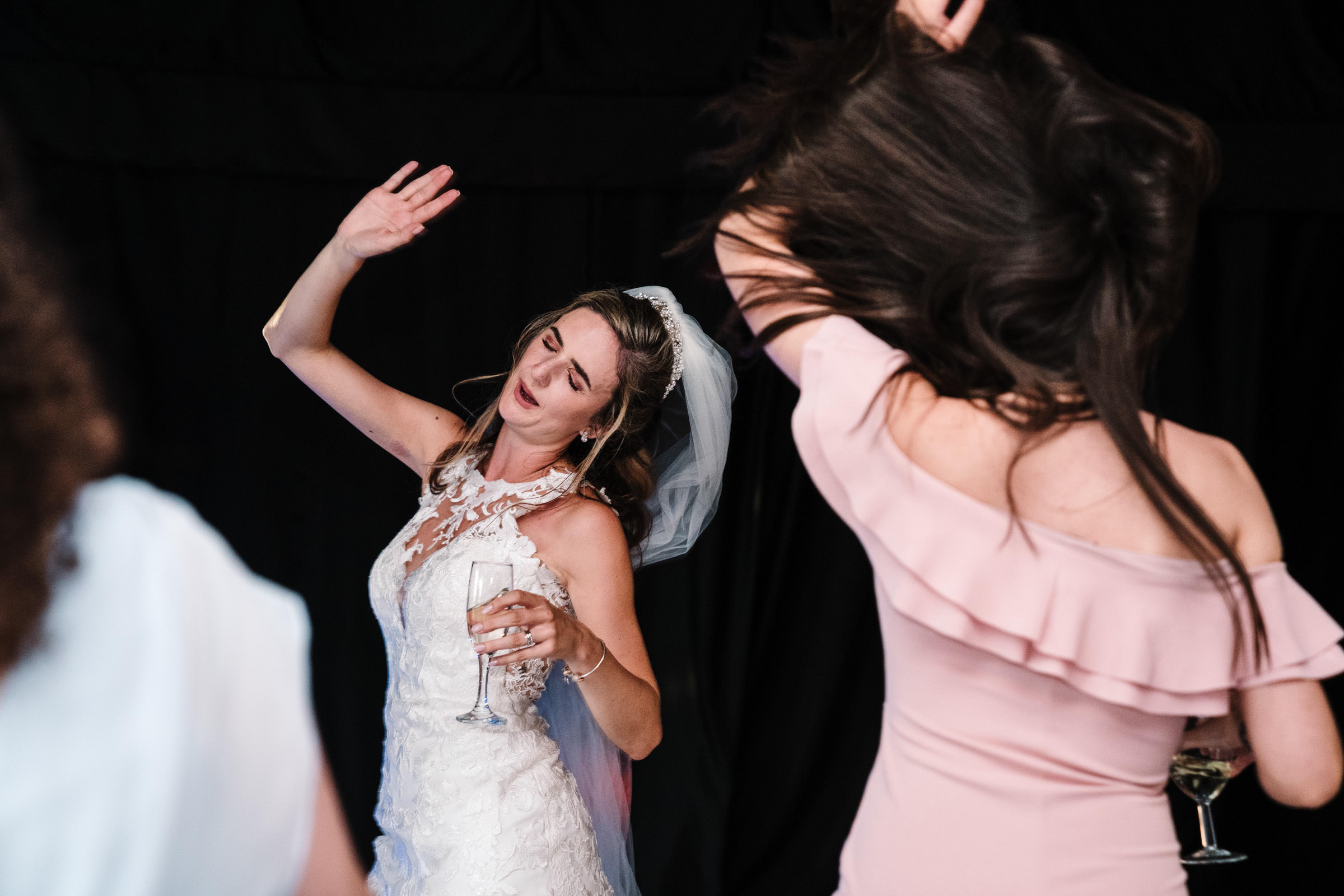 bride dancing with guests on dance floor, ashton lodge wedding