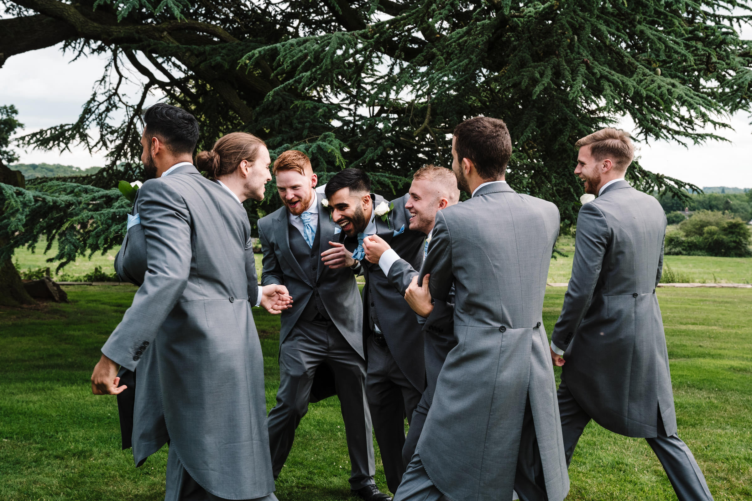 groom laughing around with groomsmen