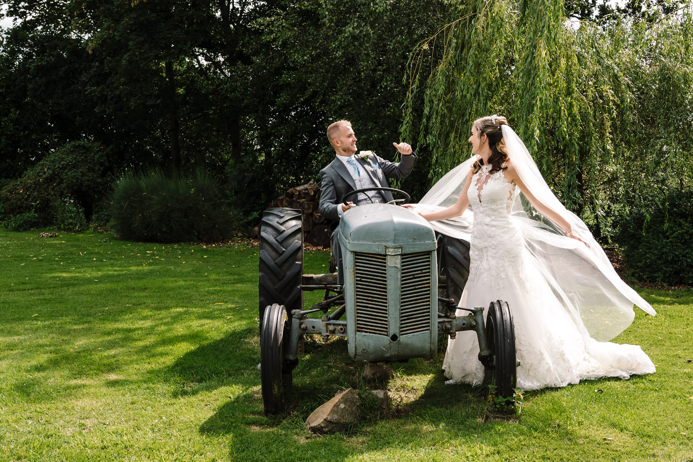 bride and groom laughing on tractor, ashton lodge